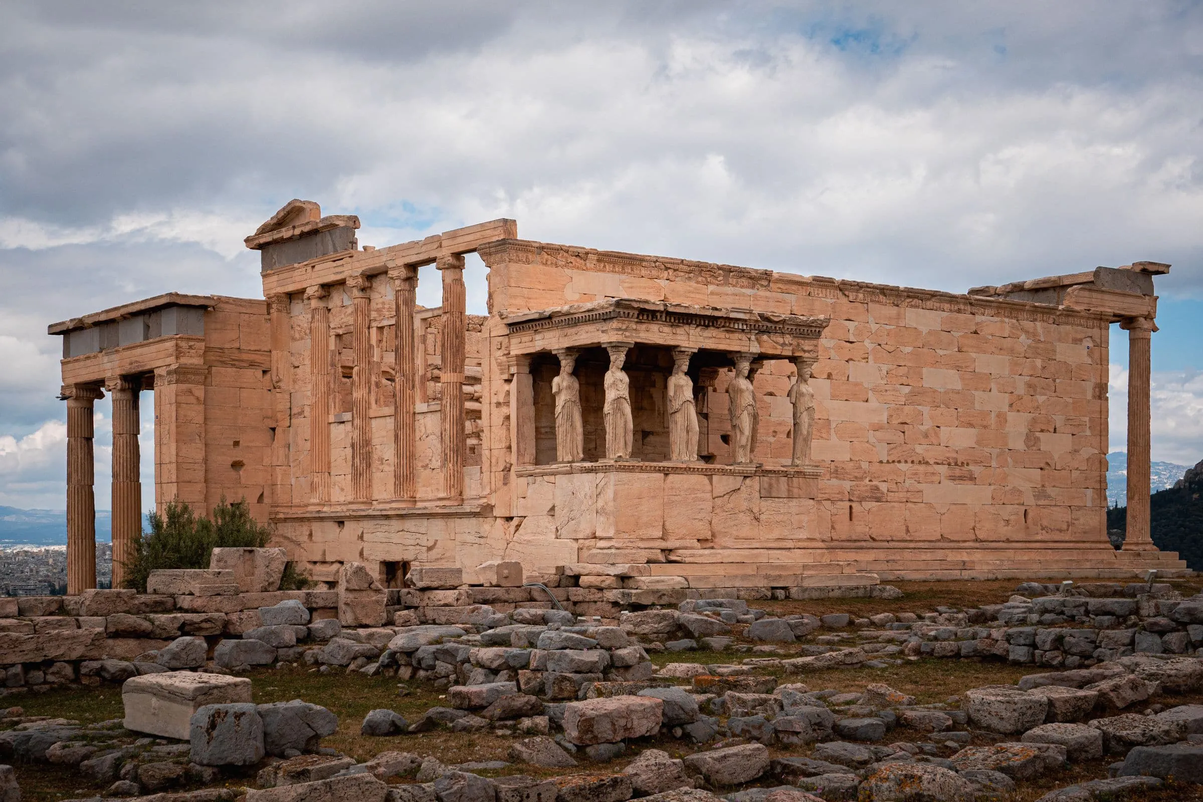 An ancient Greek temple with carved figures serving as columns