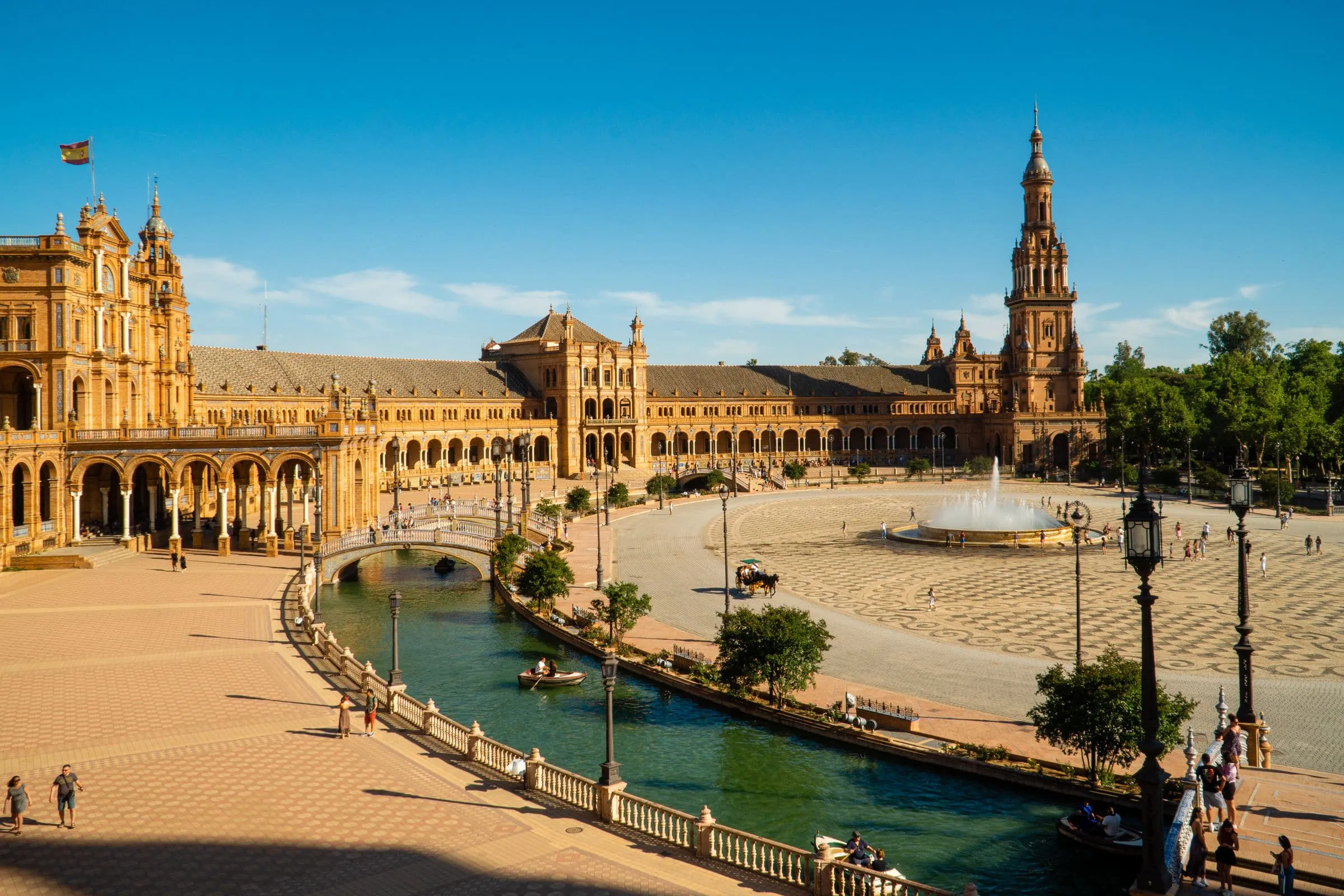 The curved brick arcades and tiled bridges of Plaza de Espana in Seville