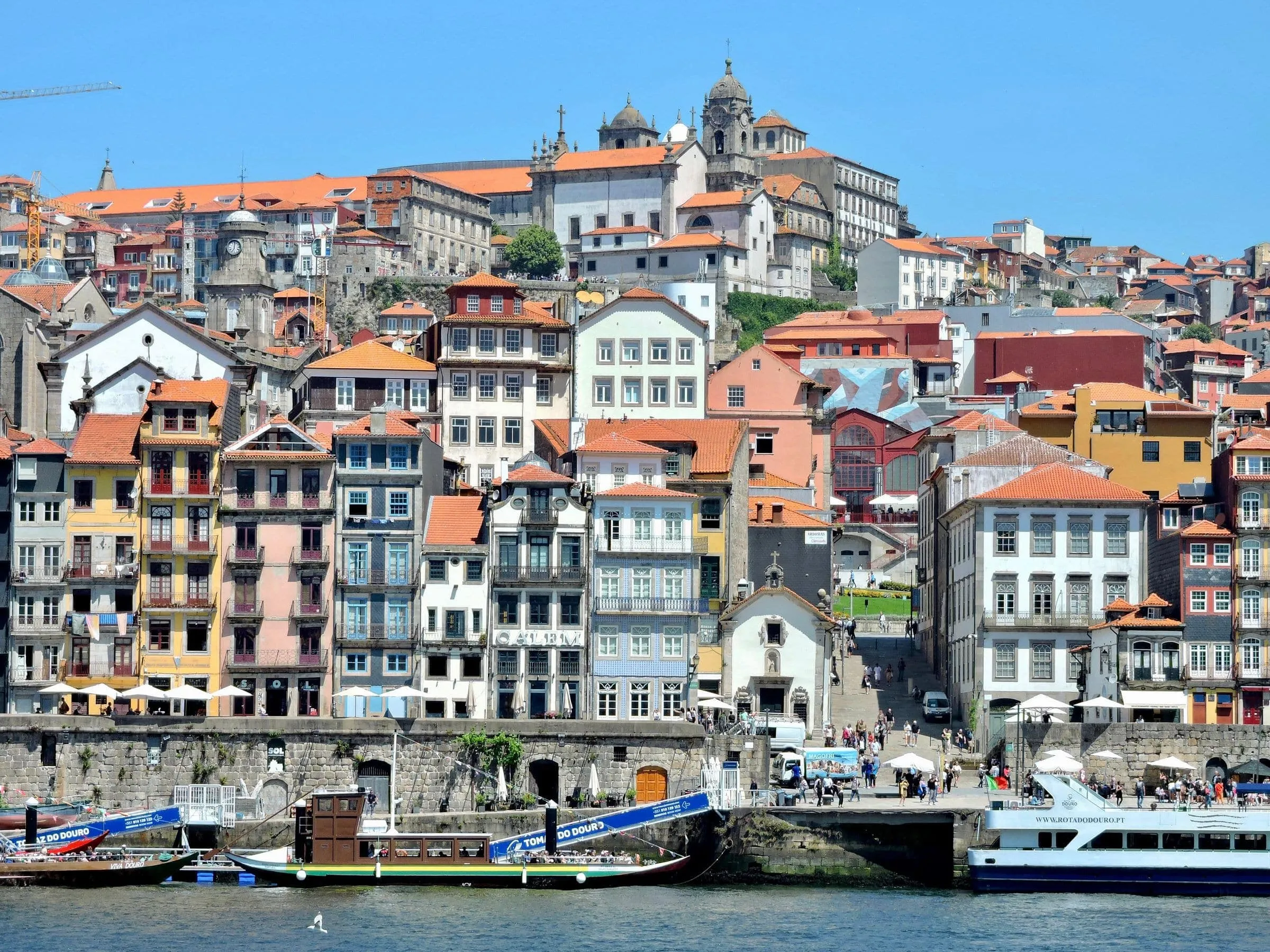 Colourful houses stacked above the Douro riverfront in Porto