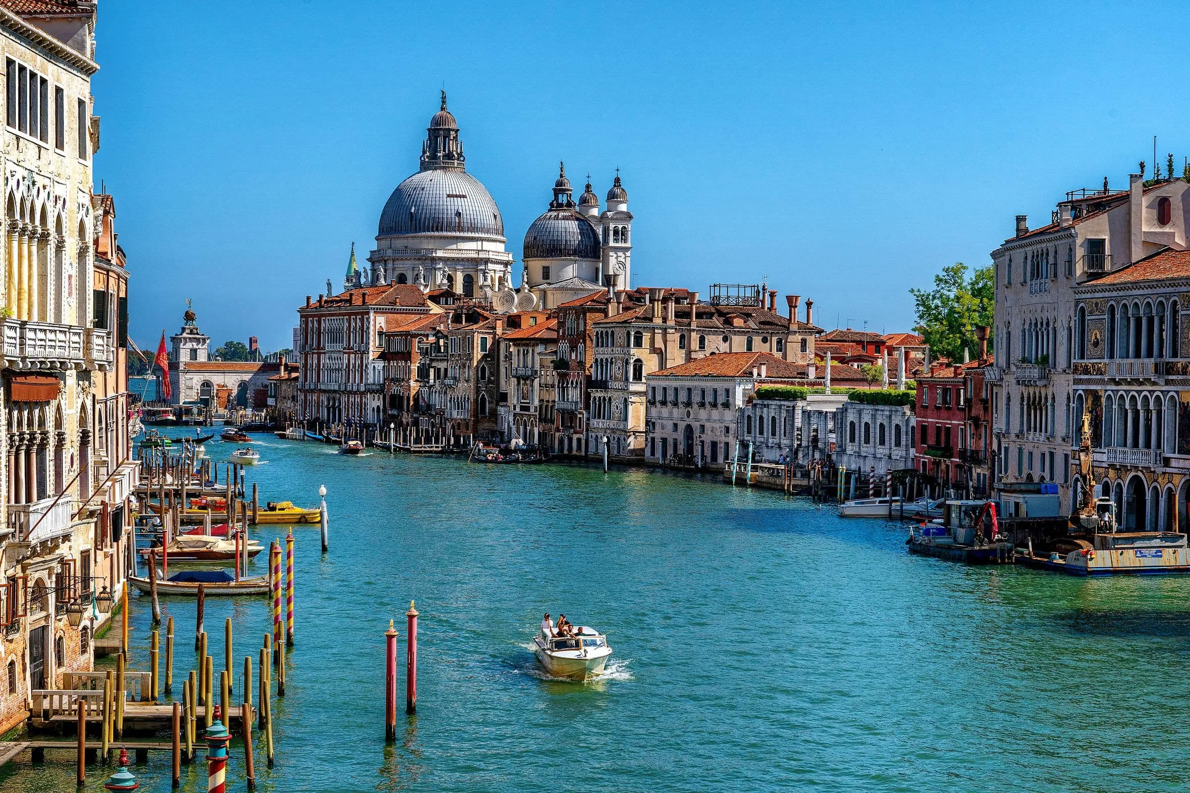 The Grand Canal in Venice with boats and a domed church at the far end