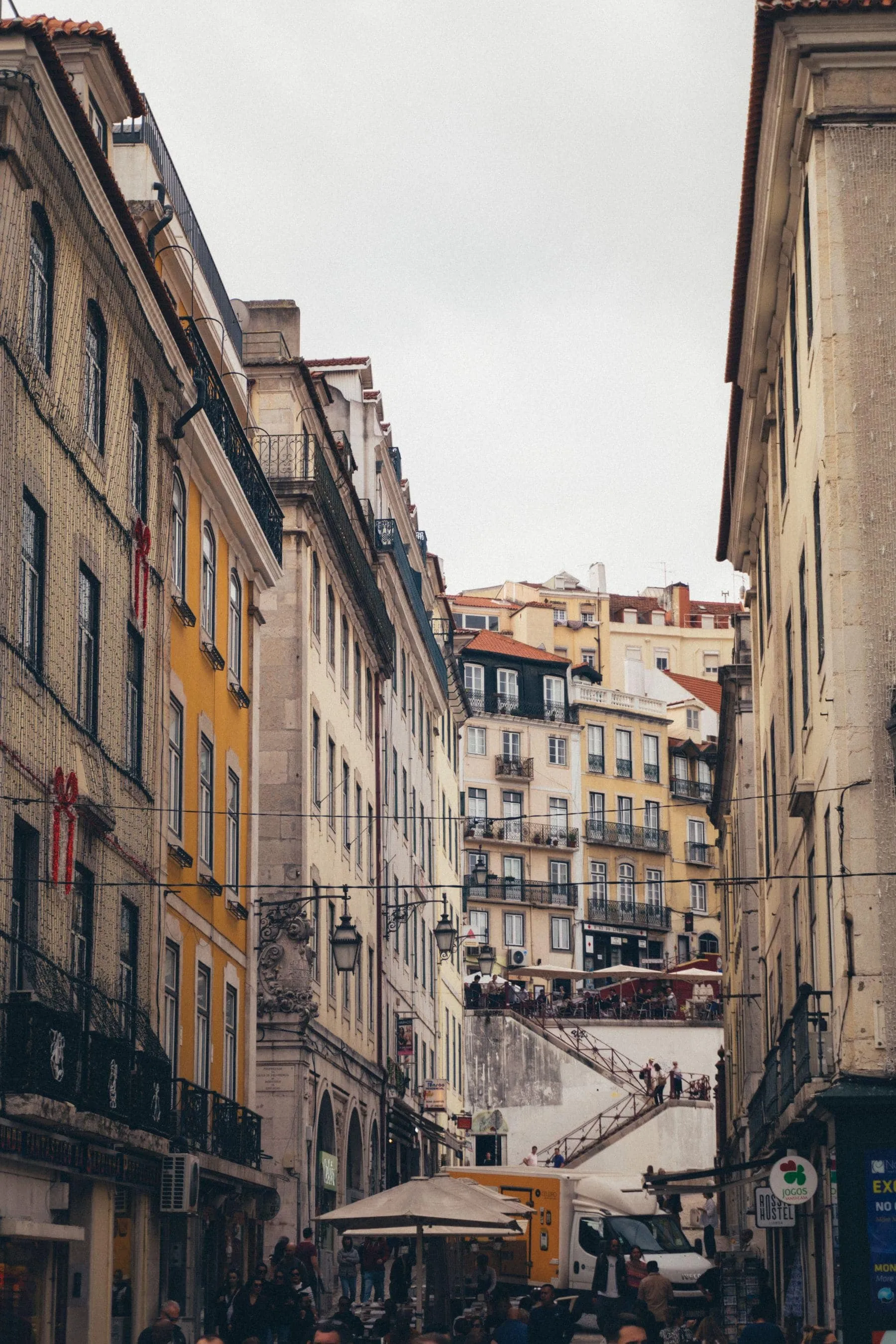 A tiled Lisbon townhouse with a stone statue in front of it