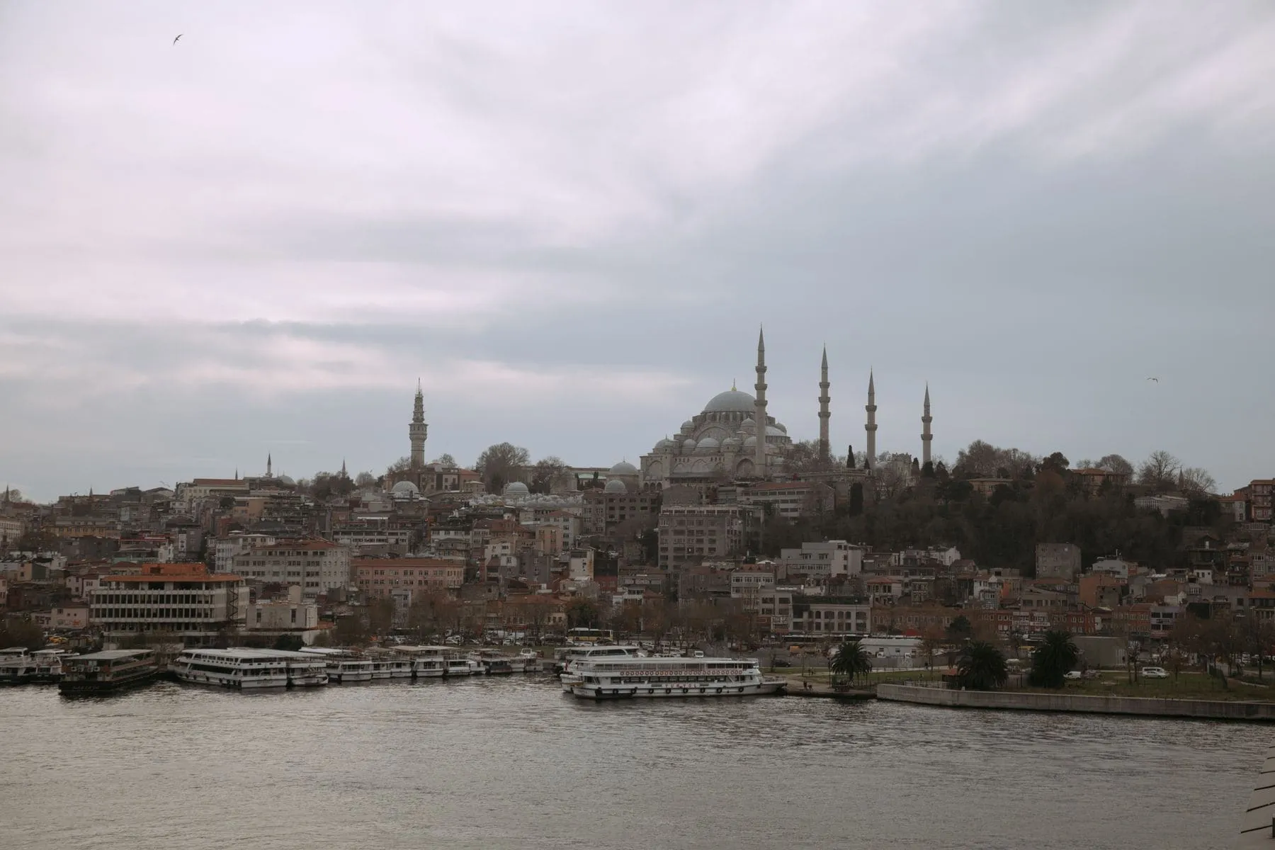 The Istanbul skyline with domes and minarets seen across the water in haze
