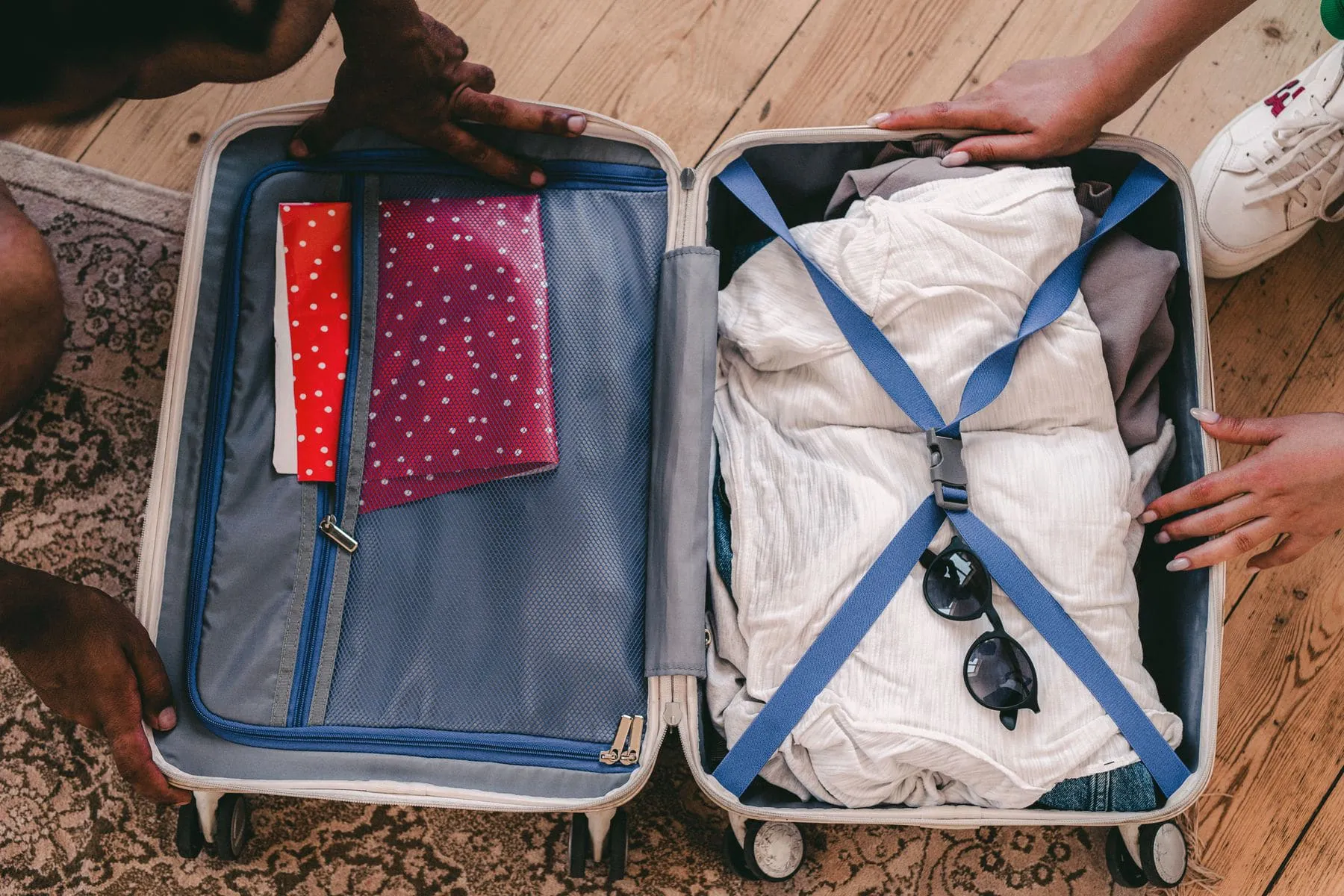 Neatly rolled clothes packed into travel cubes in an open case