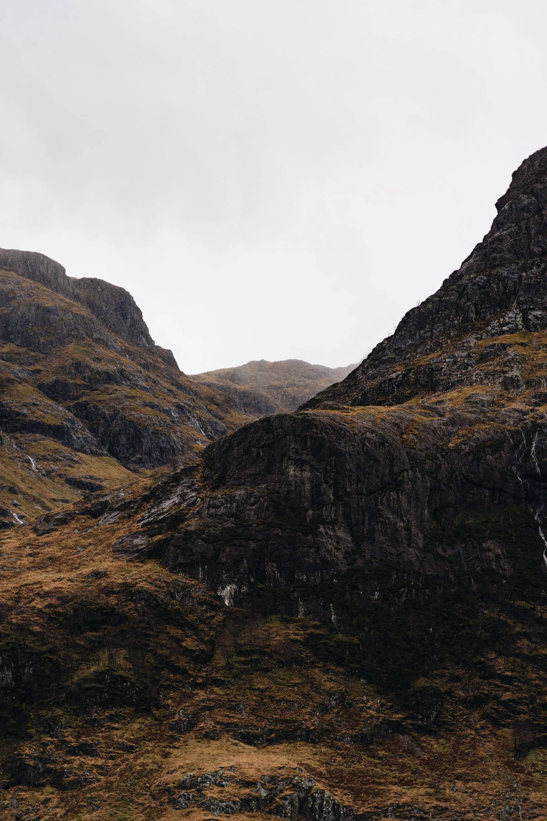 A single-track road climbing through bare rocky hills