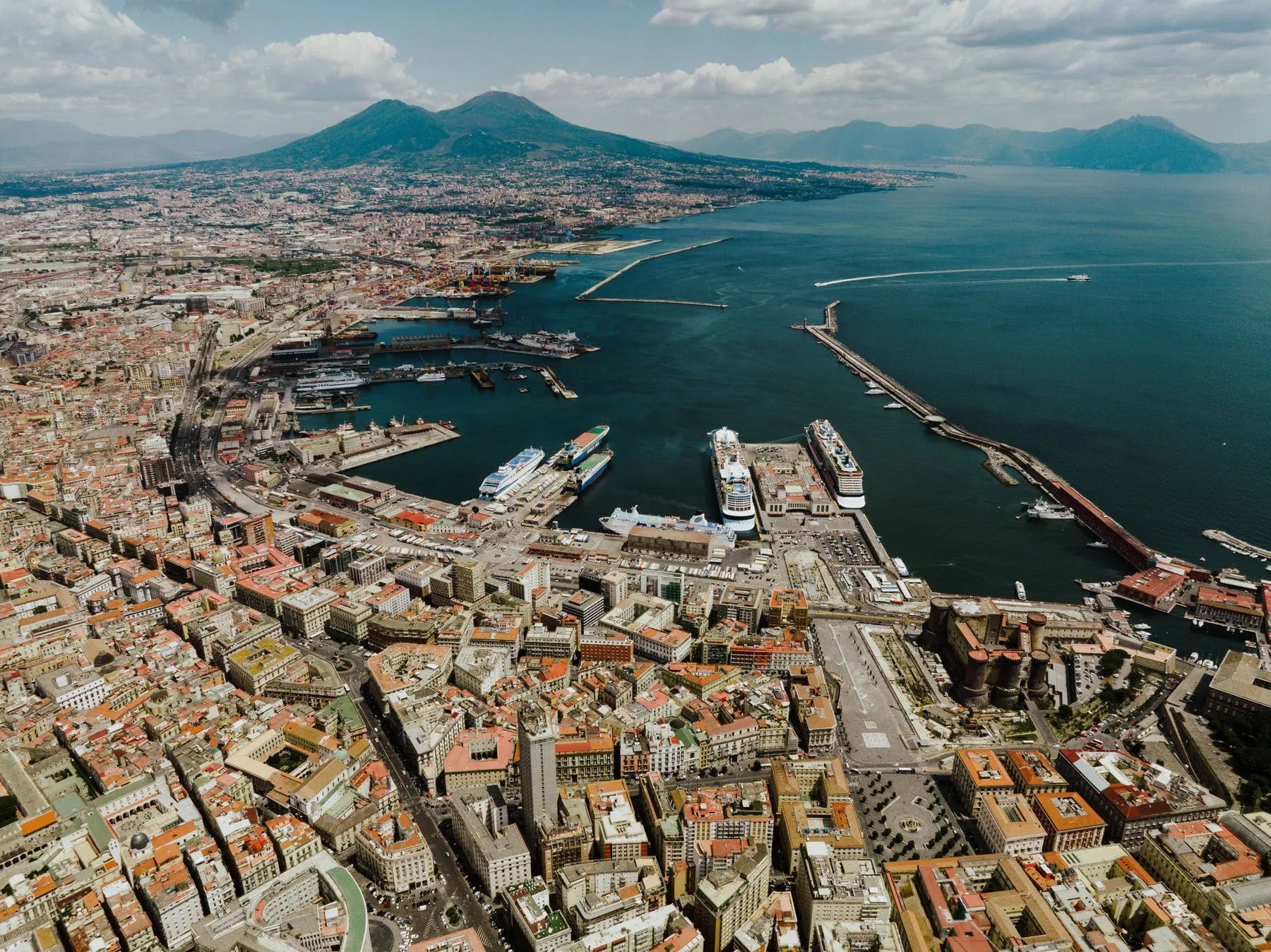 The Bay of Naples from above, with the port, the city and the volcano beyond